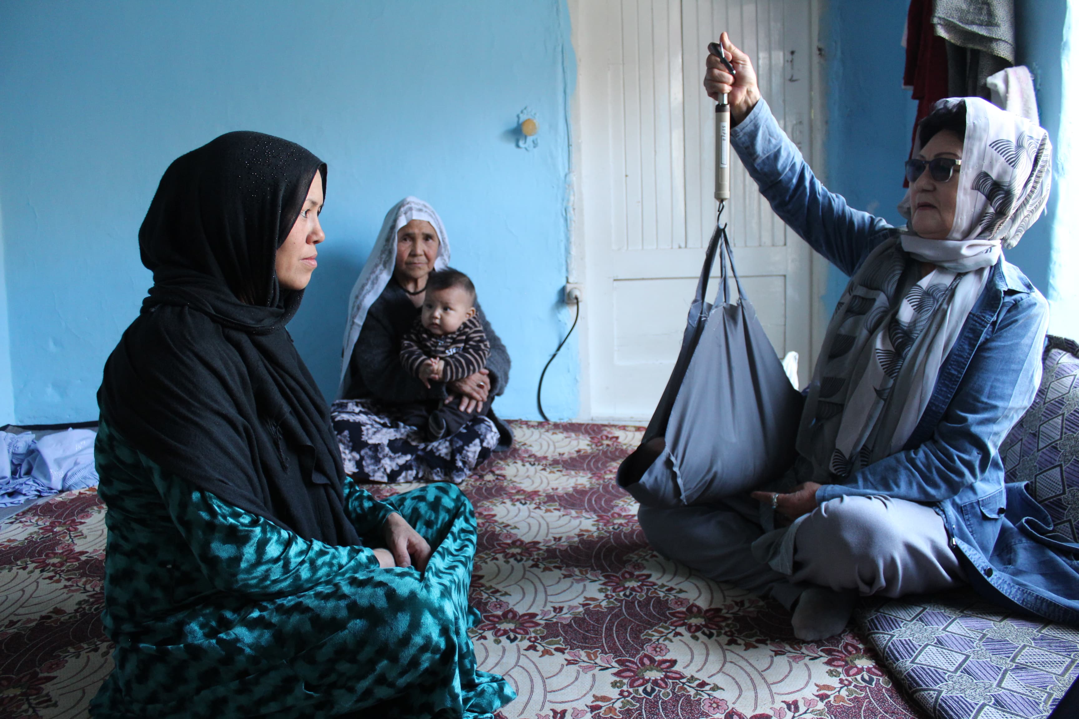 A Tdh Aghan midwife gives a consultation to a patient and her child.