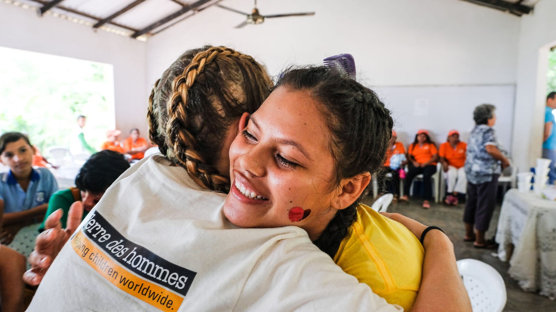 Tdh employee and woman hugging each other