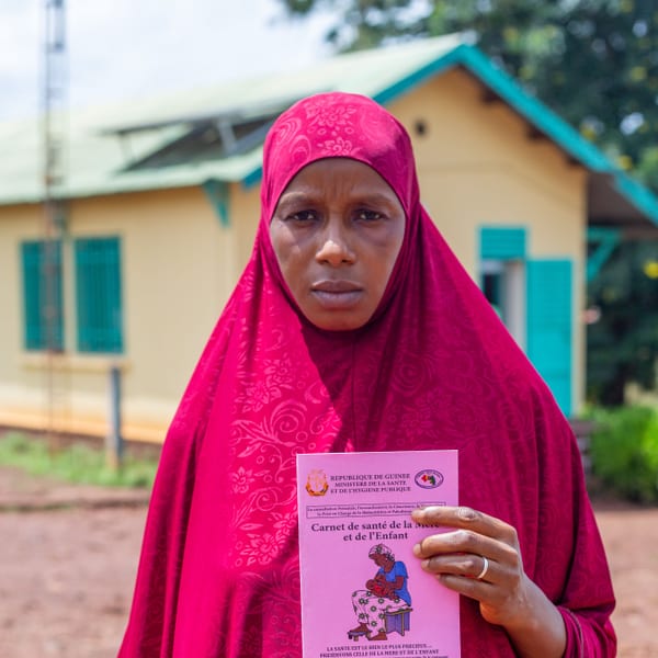 Kadiatou shows her health booklet.